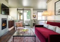 a living room with a red couch and a fireplace at Le Petit Pali at Ocean Ave in Carmel