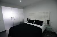 A bed or beds in a room at Apartamentos Torrecilla