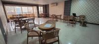 an empty restaurant with tables and chairs and a window at Best Dreams Hotel in Cairo
