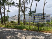 an office building with a fence and trees at Apartment Men Er Bellec-1 by Interhome in Saint-Philibert