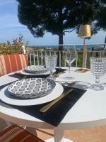 a white table with glasses and plates on it at Tra gli Alberi e il Mare in Sirolo