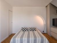 a bedroom with a bed with a striped blanket at Apartment Claire-4 by Interhome in Arcachon