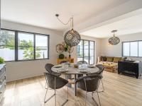 a kitchen and living room with a table and chairs at Holiday Home Saint-Colomban-2 by Interhome in Carnac