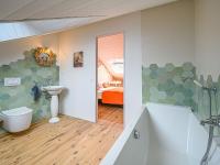 a bathroom with a toilet and a sink at Holiday Home Saint-Colomban-2 by Interhome in Carnac