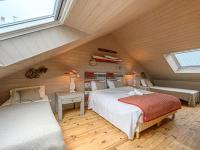 a attic bedroom with a bed and a couch at Holiday Home Saint-Colomban-2 by Interhome in Carnac