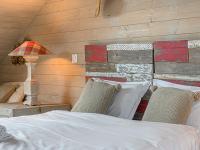 a bedroom with a bed and a table with a lamp at Holiday Home Saint-Colomban-2 by Interhome in Carnac