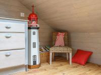 a chair and a lighthouse in a room at Holiday Home Saint-Colomban-2 by Interhome in Carnac