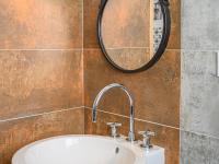 a bathroom with a sink and a mirror at Holiday Home Saint-Colomban-2 by Interhome in Carnac