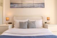 a bedroom with a white bed with two lamps at Natur in İzmir