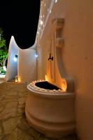 a bathroom with a toilet with lights on it at Alisaxni Studios in Argassi