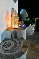 a table with a lantern with lights on it at Alisaxni Studios in Argassi