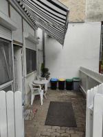 a patio with a table and chairs and trash cans at Studio-apartman Ella in Poreč