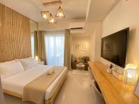 a bedroom with a large bed and a flat screen tv at Cozy Studios at Inspiria Condo Davao City beside Abreeza Mall in Davao City
