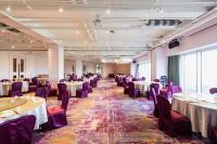 a banquet hall with tables and purple chairs at Formosa Yacht Resort in Tainan