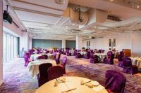 a banquet hall with tables and purple chairs at Formosa Yacht Resort in Tainan