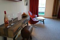 a room with chairs and a table with wine glasses at Sporthotel Igls in Innsbruck