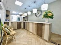 an office with a reception desk and a clock on the wall at Apartamentos Turísticos Santo Rostro in Chipiona