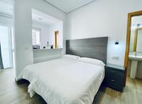 Postel nebo postele na pokoji v ubytování Apartamentos Turísticos Santo Rostro