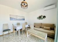 a living room with a couch and a table at Apartamentos Turísticos Santo Rostro in Chipiona