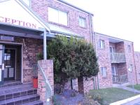 a brick building with a sign that reads reception at Acacia Snowy Motel in Jindabyne