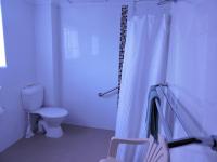 a bathroom with a toilet and a shower curtain at Acacia Snowy Motel in Jindabyne
