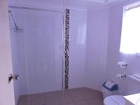 a bathroom with a glass shower with a toilet at Acacia Snowy Motel in Jindabyne