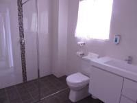 a bathroom with a toilet and a sink and a shower at Acacia Snowy Motel in Jindabyne