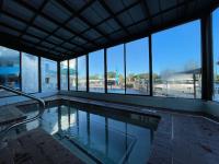 einen Pool in einem Gebäude mit Glasfenstern in der Unterkunft Polynesian Oceanfront Hotel in Myrtle Beach