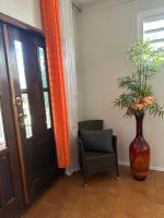 a vase of flowers sitting next to a door at Espace quietude 3 bungalows in Petit-Bourg