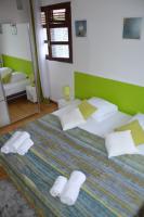 a bedroom with a large bed with white pillows at Espace quietude 3 bungalows in Petit-Bourg