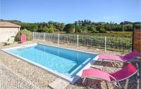 a swimming pool with two lawn chairs at 2 Bedroom Amazing Home In Saint-ambroix in Saint-Ambroix
