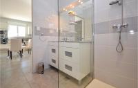 a bathroom with a shower with a sink and a mirror at 2 Bedroom Amazing Home In Saint-ambroix in Saint-Ambroix