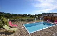 a swimming pool with two chairs and adozen chairs at 2 Bedroom Amazing Home In Saint-ambroix in Saint-Ambroix