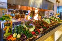 um chef em uma cozinha com vários vegetais em Grand Artos Hotel & Convention em Magelang