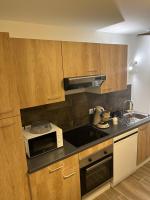 a kitchen with a microwave and a stove top oven at LE CLOS DORE in Beblenheim