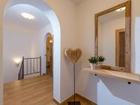 a hallway with a heart on the wall and a mirror at Appartements Schedererhaus in Going am Wilden Kaiser