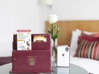 a table with books and a vase with a flower at Arlington Hotel O'Connell Bridge in Dublin