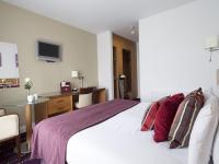 a bedroom with a white bed with red pillows at Arlington Hotel O'Connell Bridge in Dublin