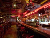 a bar with a lot of tables and chairs at Arlington Hotel O'Connell Bridge in Dublin