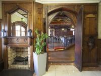 an entrance to a building with a fireplace and a staircase at Arlington Hotel O'Connell Bridge in Dublin