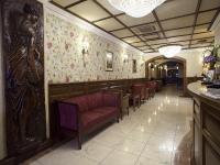 a restaurant with a row of chairs and floral wallpaper at Arlington Hotel O'Connell Bridge in Dublin