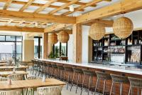 a restaurant with tables and chairs and a bar at SpringHill Suites by Marriott Jacksonville Beach Oceanfront in Jacksonville Beach