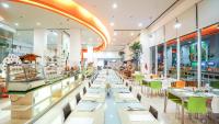 a view of a restaurant with tables and chairs at HARRIS Hotel Batam Center in Batam Center