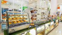 a bakery with a bunch of pastries in a display case at HARRIS Hotel Batam Center in Batam Center
