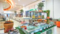 a buffet line with food on display in a store at HARRIS Hotel Batam Center in Batam Center