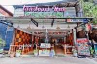 a store with tables and chairs in front of it at GP House Krabi Aonang Beach in Ao Nang Beach