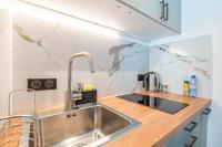 a kitchen with a stainless steel sink and a counter at Le Petit Rex in Paris