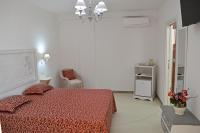 A bed or beds in a room at Arbor Exclusive B&B