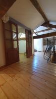 an empty room with wooden floors and doors at Chateau Mano in Mairé-lʼEveseault