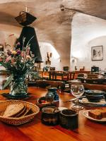 een houten tafel met eten en een vaas met bloemen bij Auberge l'Estoilies in Saint-Véran
